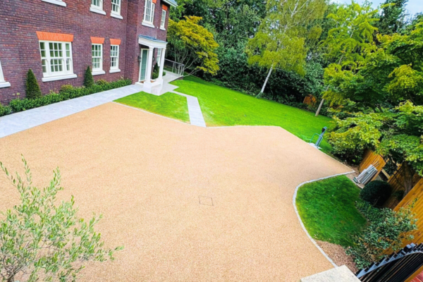 Spacious resin driveway beside elegant house.