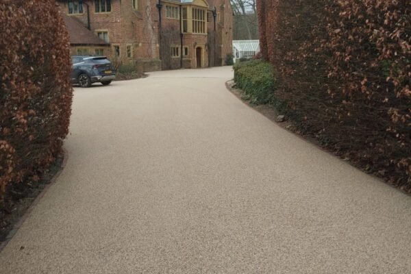 Resin driveway leading to a large house
