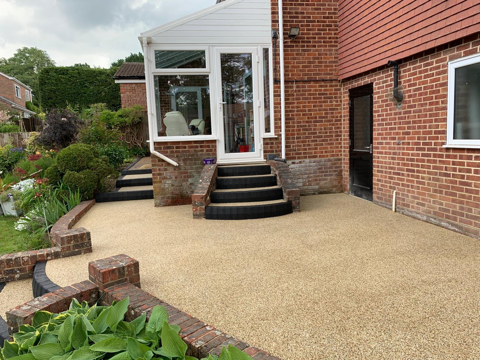 Resin patio installation showing clean edge control