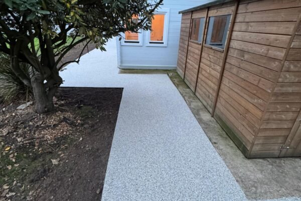 Resin surfacing surrounding garden cabin and shed