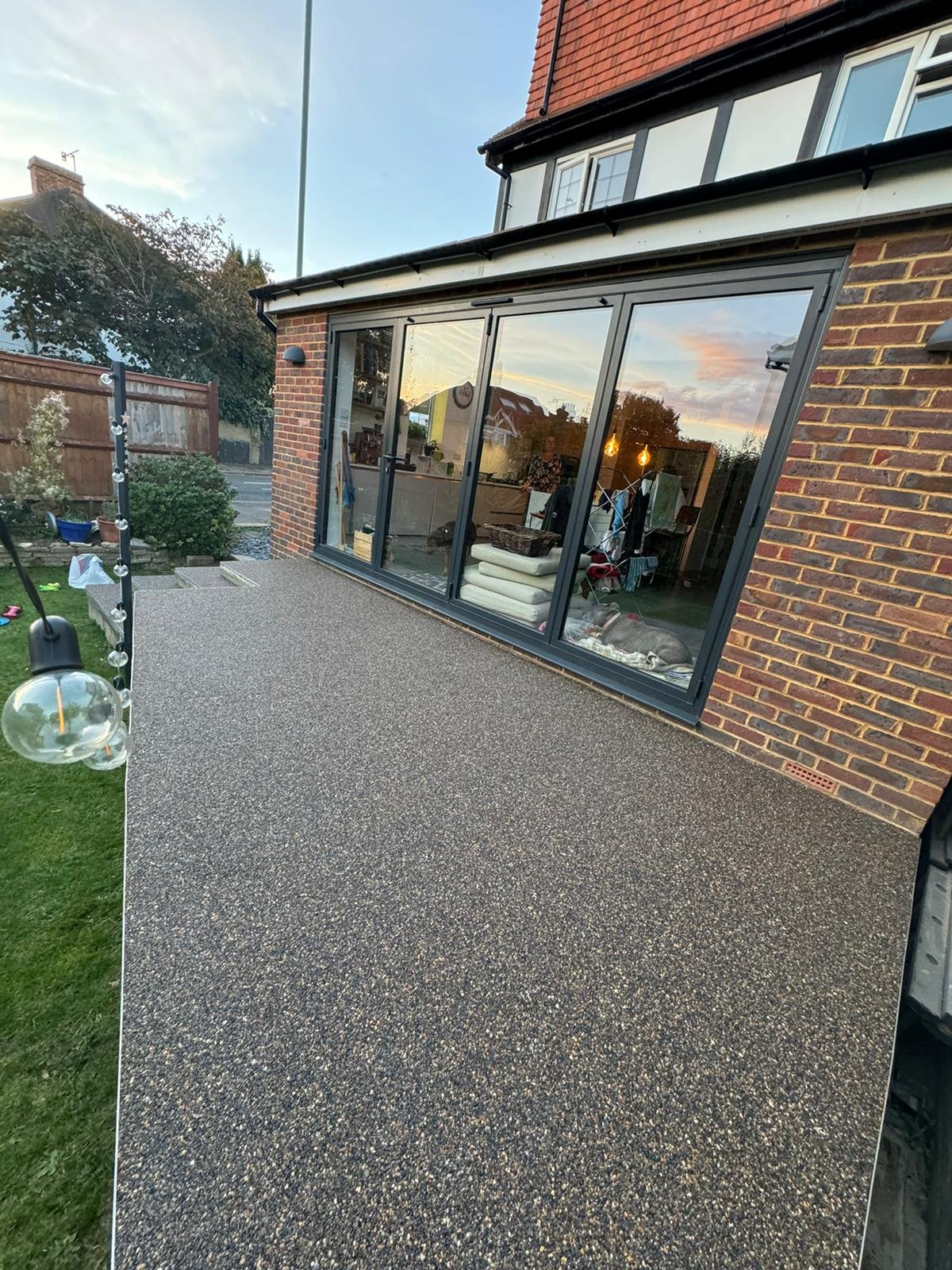 Decorative resin patio surface with stone effect finish