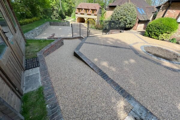 Resin patio with landscaped garden features.